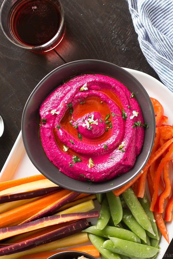 This Creamy Beet Hummus with Yogurt will soon be your favorite way to eat your beets! Roasted beets, tahini and yogurt are blended together to make a creamy and healthy dip with a bright pink color that will blow your mind!