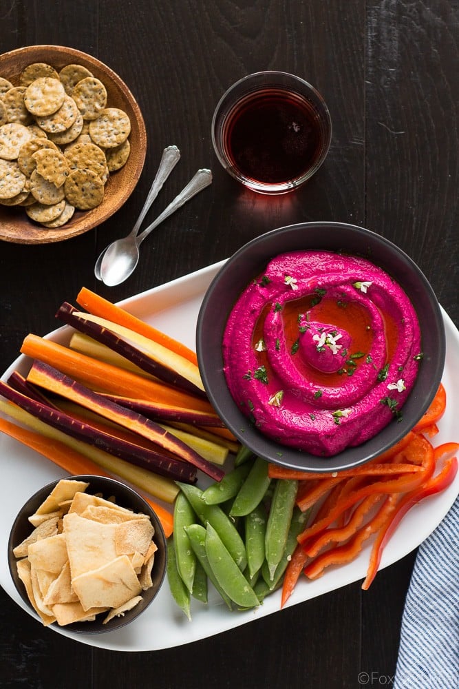 This Creamy Beet Hummus with Yogurt will soon be your favorite way to eat your beets! Roasted beets, tahini and yogurt are blended together to make a creamy and healthy dip with a bright pink color that will blow your mind!