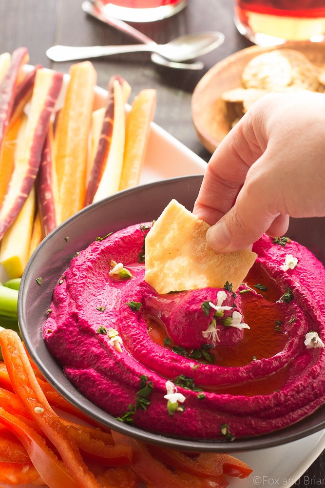 This Creamy Beet Hummus with Yogurt will soon be your favorite way to eat your beets! Roasted beets, tahini and yogurt are blended together to make a creamy and healthy dip with a bright pink color that will blow your mind!