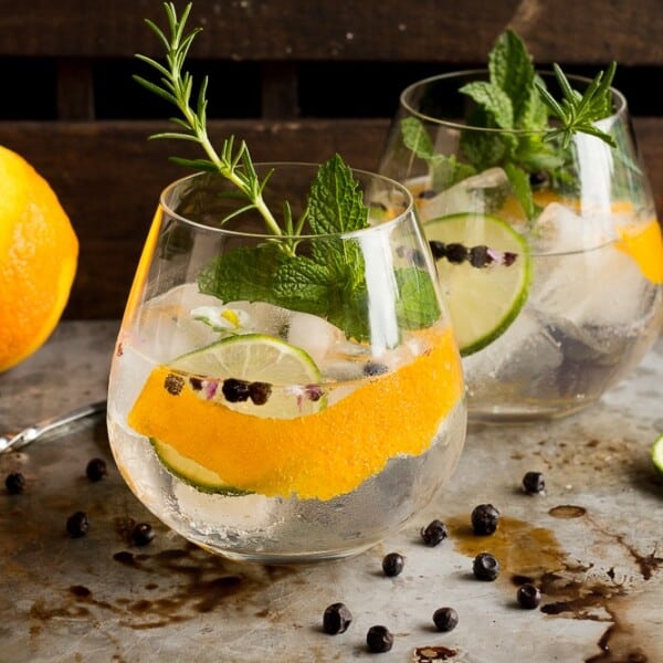 These Spanish Style Gin Tonics are the perfect refreshing sipper for a hot summer day! Ice cold, filled with aromatics, gin and high quality tonic, they are sure to cool you down!