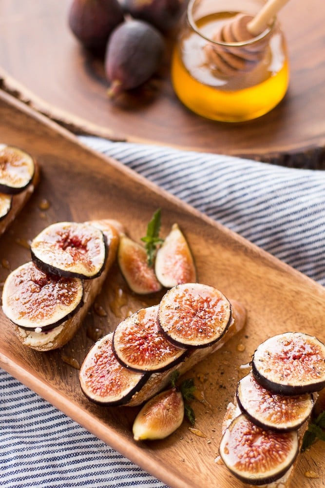 These Fig and Goat Cheese Crostini with Honey are one of my favorite simple summer appetizers. Using fresh figs, goat cheese, honey and pepper, these are an easy but elegant starter or snack.