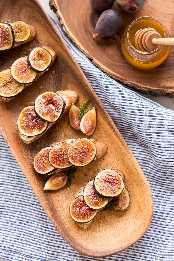 These Fig and Goat Cheese Crostini with Honey are one of my favorite simple summer appetizers. Using fresh figs, goat cheese, honey and pepper, these are an easy but elegant starter or snack.