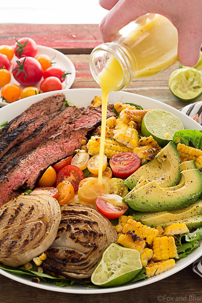 This Mexican Grilled Flank Steak Salad with Honey Lime Dressing has a smoky spiced grilled flank steak, charred corn, grilled onions, creamy avocado and a zingy honey lime dressing. Quick to make inside on the stove or outside on the grill!
