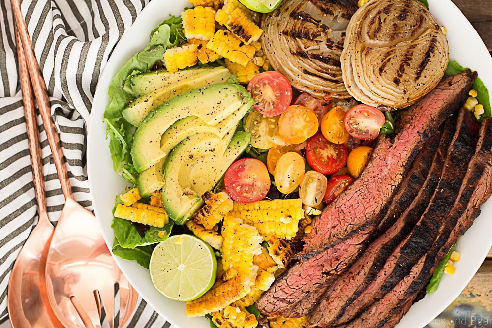 This Mexican Grilled Flank Steak Salad with Honey Lime Dressing has a smoky spiced grilled flank steak, charred corn, grilled onions, creamy avocado and a zingy honey lime dressing. Quick to make inside on the stove or outside on the grill!