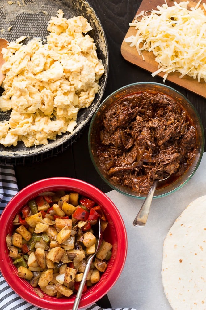 These Make Ahead Beef Breakfast Burritos are freezer friendly! Using tender, slow cooker shredded beef, breakfast potatoes, eggs and cheese, they can be made ahead of time and frozen. Just reheat them in the morning for a quick and hearty breakfast! #sponsored #WABeefLove