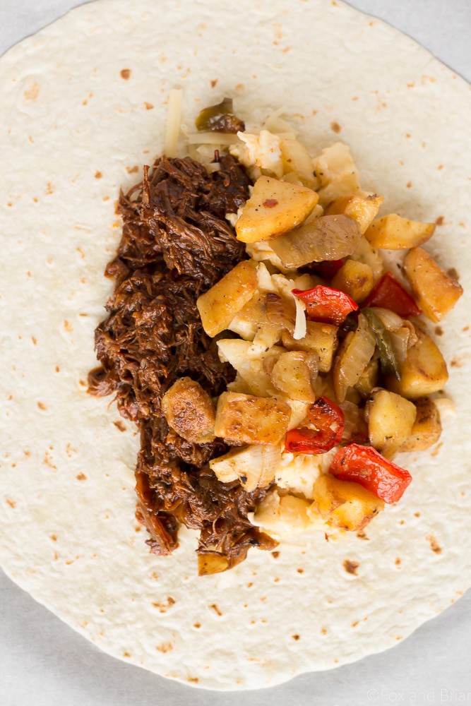 These Make Ahead Beef Breakfast Burritos are freezer friendly! Using tender, slow cooker shredded beef, breakfast potatoes, eggs and cheese, they can be made ahead of time and frozen. Just reheat them in the morning for a quick and hearty breakfast! #sponsored #WABeefLove