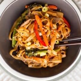 This quick and easy Beef Noodle Stir Fry takes under 30 minutes and is easily made gluten free! Full of veggies, beef and a flavorful sauce, your whole family will love it!