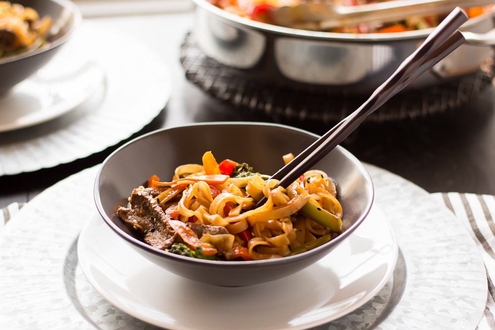 This quick and easy Beef Noodle Stir Fry takes under 30 minutes and is easily made gluten free! Full of veggies, beef and a flavorful sauce, your whole family will love it!