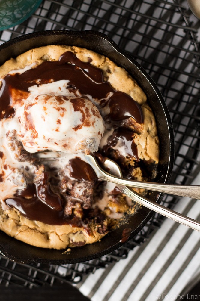 This Chocolate Chip Cookie Blondie Skillet Sundae For Two is the perfect dessert to whip up when you want something sweet but don't want to make a huge batch! A thick and chewy chocolate chip cookie baked in a mini skillet topped with ice cream and a rich chocolate sauce will cure any sweet tooth!