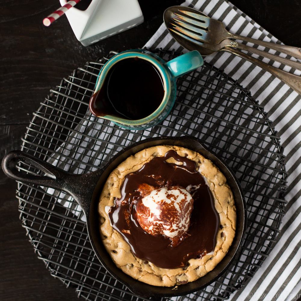 This Chocolate Chip Cookie Blondie Skillet Sundae For Two is the perfect dessert to whip up when you want something sweet but don't want to make a huge batch! A thick and chewy chocolate chip cookie baked in a mini skillet topped with ice cream and a rich chocolate sauce will cure any sweet tooth!