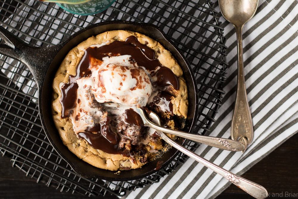 This Chocolate Chip Cookie Blondie Skillet Sundae For Two is the perfect dessert to whip up when you want something sweet but don't want to make a huge batch! A thick and chewy chocolate chip cookie baked in a mini skillet topped with ice cream and a rich chocolate sauce will cure any sweet tooth!