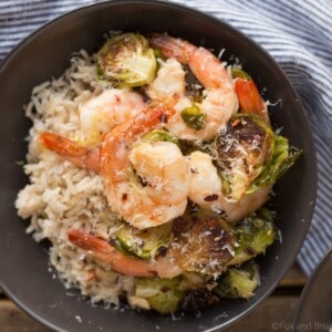 These Roasted Shrimp and Brussels Sprouts are a quick and easy dinner. Lemon and garlic make this a flavorful sheet pan dinner you can make in about 20 minutes!