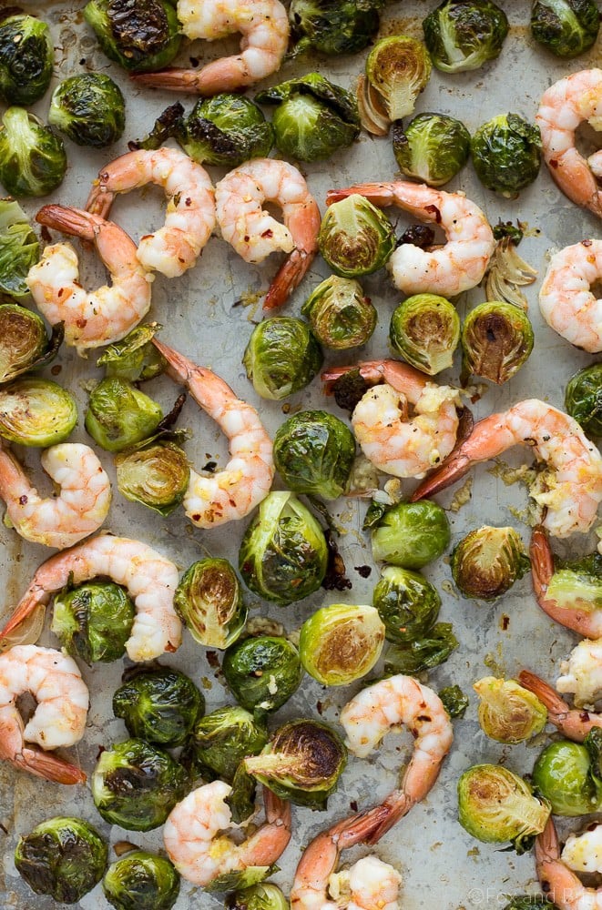 These Roasted Shrimp and Brussels Sprouts are a quick and easy dinner. Lemon and garlic make this a flavorful sheet pan dinner you can make in about 20 minutes!