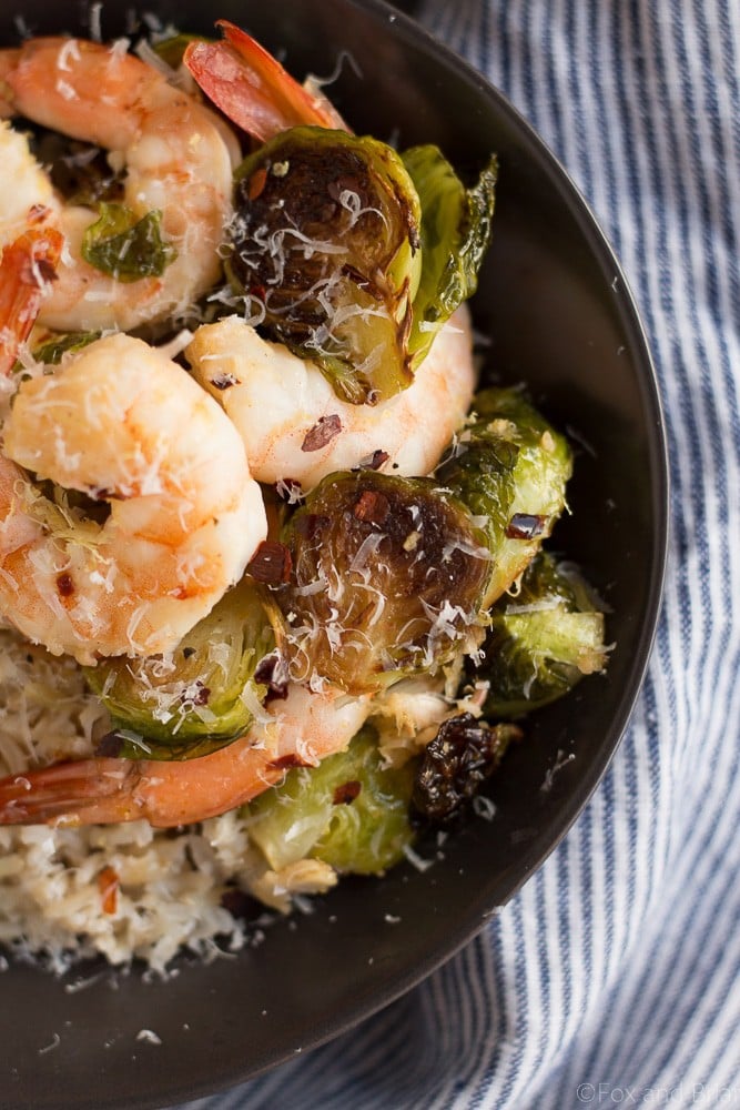 These Roasted Shrimp and Brussels Sprouts are a quick and easy dinner. Lemon and garlic make this a flavorful sheet pan dinner you can make in about 20 minutes!