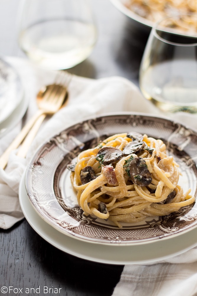 Pasta with bacon and mushrooms in a creamy white wine sauce