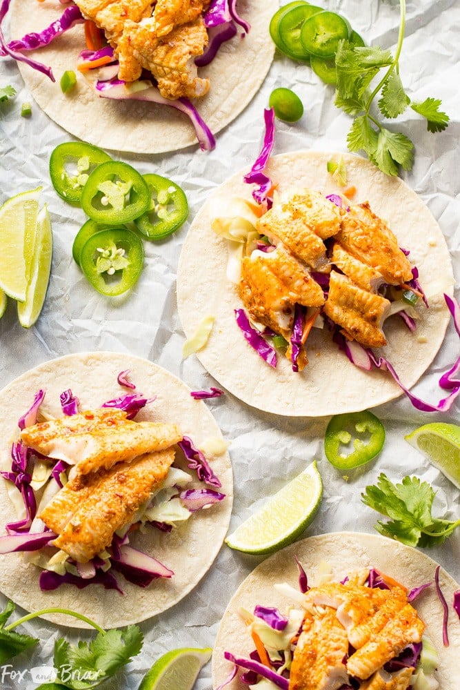 Chipotle Lime Fish Tacos with crunchy jalapeno lime slaw and creamy avocado crema are an easy and flavorful weeknight dinner! Taco Recipe | Baja Fish Tacos | Spicy Fish Tacos | Fish Recipes | Cinco De Mayo Recipes