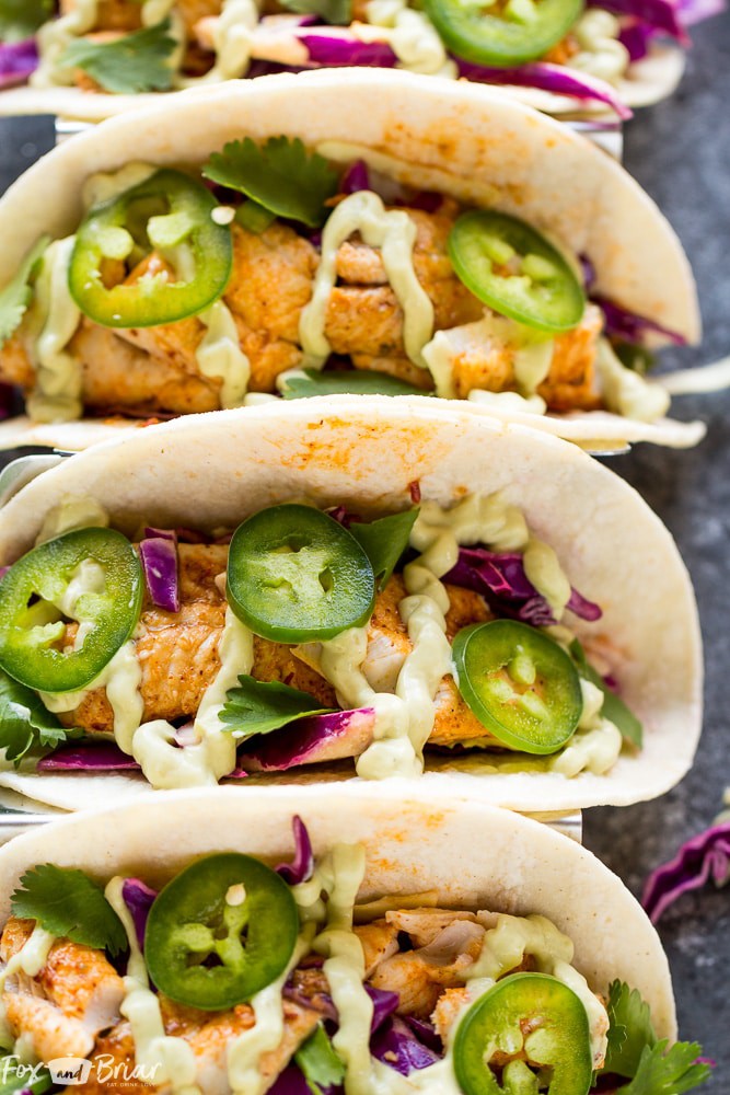 Chipotle Lime Fish Tacos with crunchy jalapeno lime slaw and creamy avocado crema are an easy and flavorful weeknight dinner! Taco Recipe | Baja Fish Tacos | Spicy Fish Tacos | Fish Recipes | Cinco De Mayo Recipes