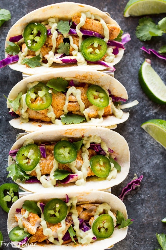 Chipotle Lime Fish Tacos with crunchy jalapeno lime slaw and creamy avocado crema are an easy and flavorful weeknight dinner! Taco Recipe | Baja Fish Tacos | Spicy Fish Tacos | Fish Recipes | Cinco De Mayo Recipes