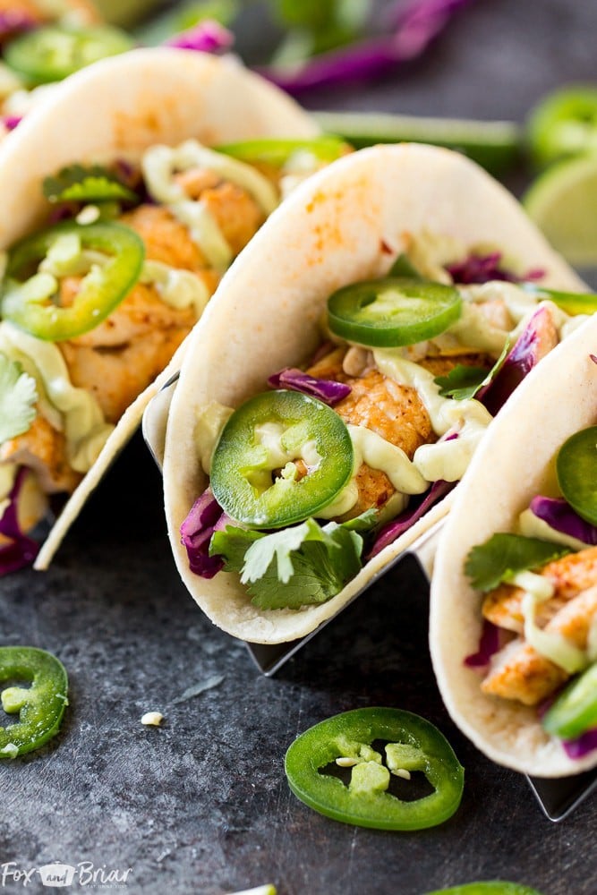 Chipotle Lime Fish Tacos with crunchy jalapeno lime slaw and creamy avocado crema are an easy and flavorful weeknight dinner! Taco Recipe | Baja Fish Tacos | Spicy Fish Tacos | Fish Recipes | Cinco De Mayo Recipes