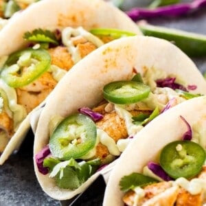 Chipotle Lime Fish Tacos with crunchy jalapeno lime slaw and creamy avocado crema are an easy and flavorful weeknight dinner! Taco Recipe | Baja Fish Tacos | Spicy Fish Tacos | Fish Recipes | Cinco De Mayo Recipes