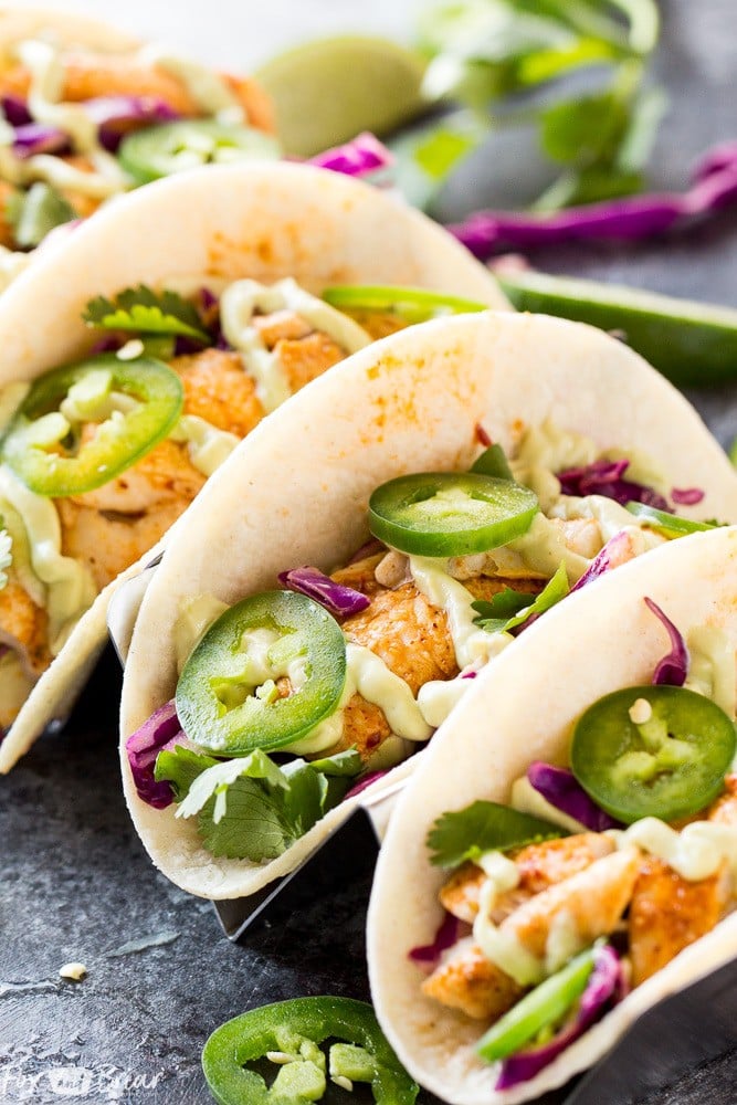 Chipotle Lime Fish Tacos with crunchy jalapeno lime slaw and creamy avocado crema are an easy and flavorful weeknight dinner! Taco Recipe | Baja Fish Tacos | Spicy Fish Tacos | Fish Recipes | Cinco De Mayo Recipes