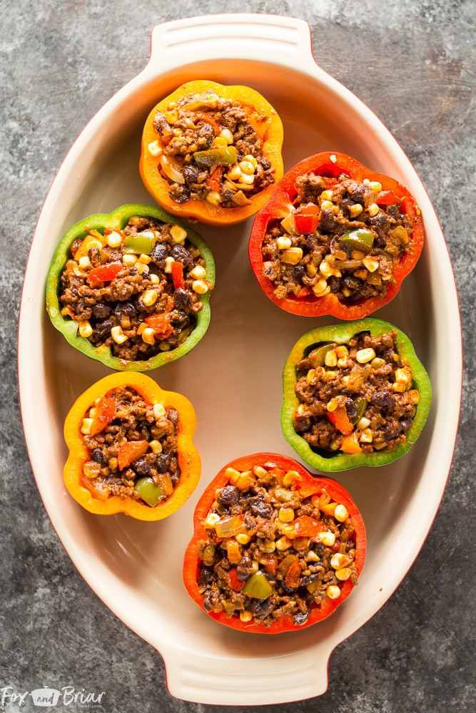 These Tex-Mex Stuffed Bell Peppers are a grain-free, gluten-free family friendly dinner with Mexican flair. Sure to satisfy everyone at the dinner table! #ad @krogerco | Gluten free dinner | Easy Dinner Recipe | Ground Beef Recipes | Stuffed Bell Peppers 