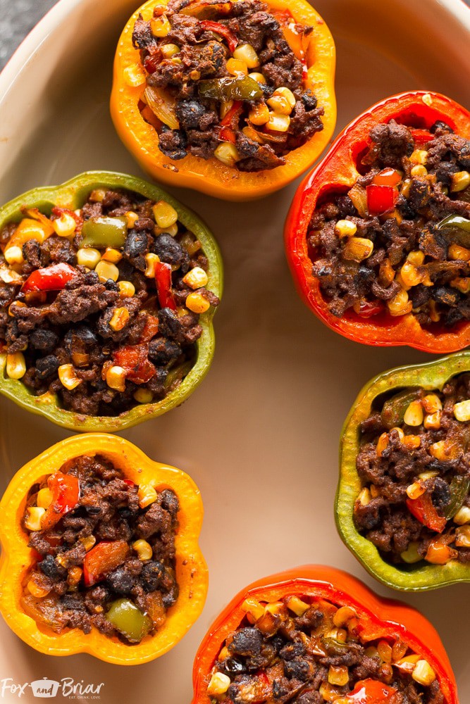 These Tex-Mex Stuffed Bell Peppers are a grain-free, gluten-free family friendly dinner with Mexican flair. Sure to satisfy everyone at the dinner table! #ad @krogerco | Gluten free dinner | Easy Dinner Recipe | Ground Beef Recipes | Stuffed Bell Peppers 