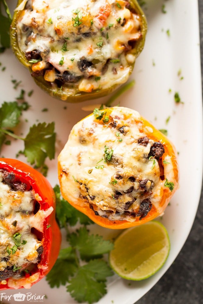 These Tex-Mex Stuffed Bell Peppers are a grain-free, gluten-free family friendly dinner with Mexican flair. Sure to satisfy everyone at the dinner table! #ad @krogerco | Gluten free dinner | Easy Dinner Recipe | Ground Beef Recipes | Stuffed Bell Peppers 