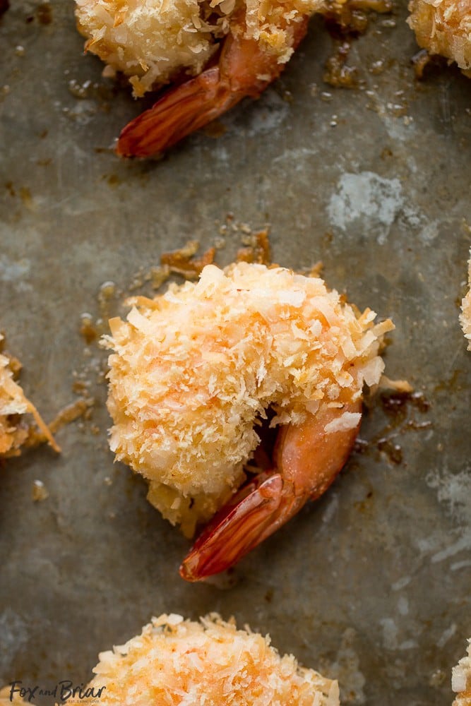 These Baked Coconut Shrimp are golden, crispy and full of flavor. You won't even need a dipping sauce! These are the BEST baked coconut shrimp I have ever made! | How to make coconut shrimp | Baked coconut shrimp | skinny coconut shrimp | 