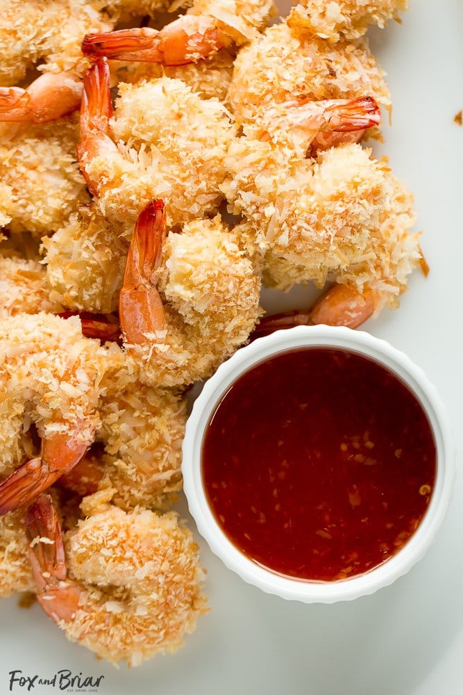 These Baked Coconut Shrimp are golden, crispy and full of flavor. You won't even need a dipping sauce! These are the BEST baked coconut shrimp I have ever made! | How to make coconut shrimp | Baked coconut shrimp | skinny coconut shrimp | 