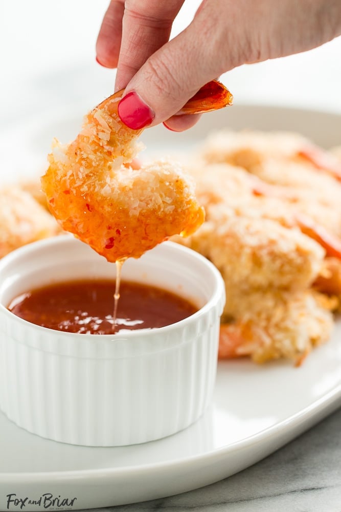 These Baked Coconut Shrimp are golden, crispy and full of flavor. You won't even need a dipping sauce! These are the BEST baked coconut shrimp I have ever made! | How to make coconut shrimp | Baked coconut shrimp | skinny coconut shrimp | 