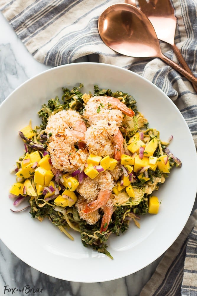 This delicious and tropical Coconut Shrimp Salad is topped with a fresh mango salsa and the most addictive peanut sauce dressing ever!