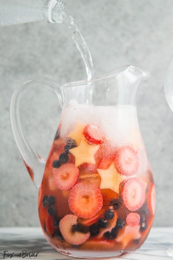These Red, White, and Blue Wine Sparklers are the perfect festive drink for the Fourth of July. Refreshing and light on alcohol makes for easy drinking on a hot summer day! |patriotic drinks | red white and blue drinks | patriotic recipes | red white and blue recipe | fourth of july recipe