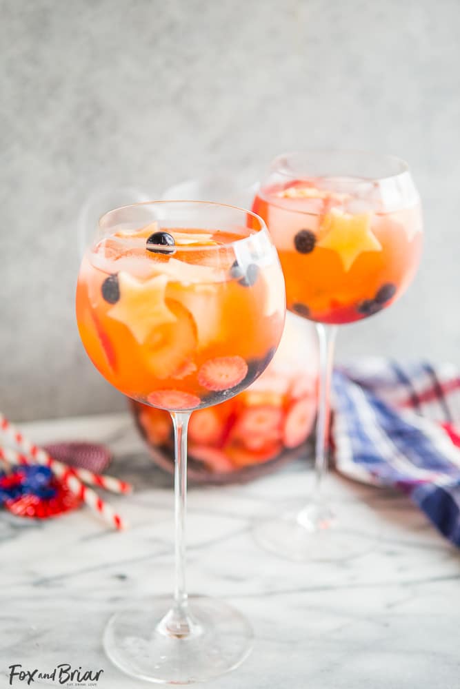 These Red, White, and Blue Wine Sparklers are the perfect festive drink for the Fourth of July. Refreshing and light on alcohol makes for easy drinking on a hot summer day! |patriotic drinks | red white and blue drinks | patriotic recipes | red white and blue recipe | fourth of july recipe