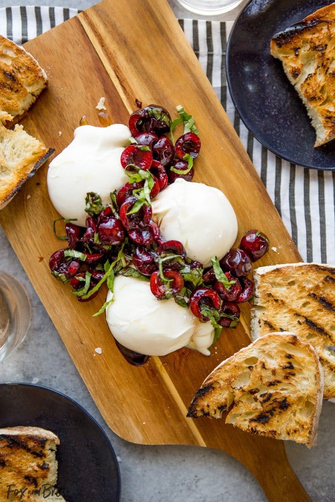 This Burrata with Balsamic Cherries and Basil the ultimate summer appetizer! Creamy, fresh burrata paired with juicy cherries and fragrant basil uses summer produce at its best, and no cooking required! Summer appetizers | Cherry Recipes | basil Recipes | burrata Recipes | party appetizers