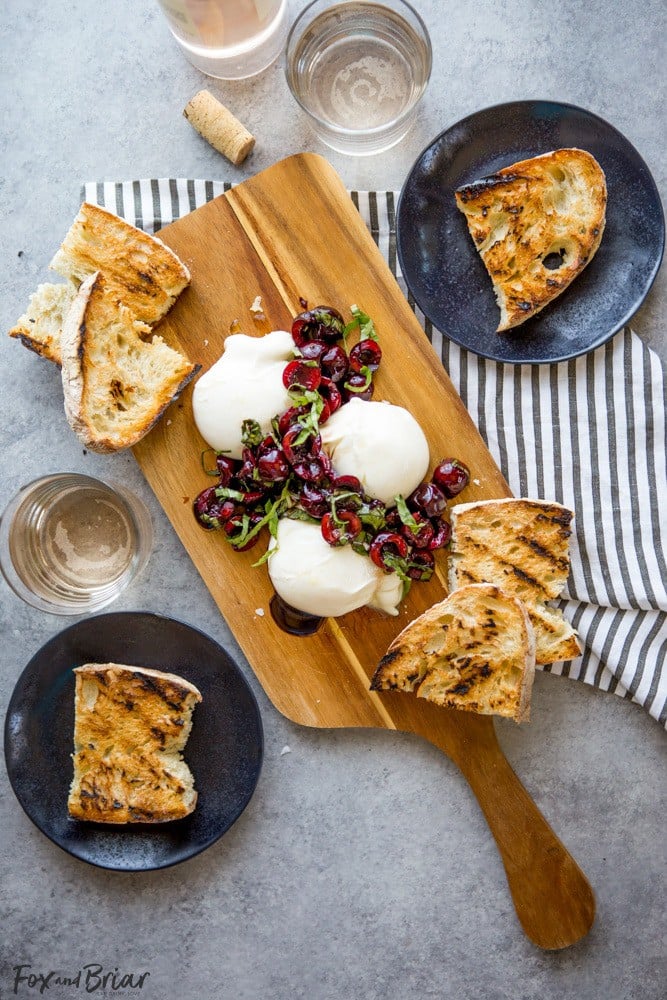 This Burrata with Balsamic Cherries and Basil the ultimate summer appetizer! Creamy, fresh burrata paired with juicy cherries and fragrant basil uses summer produce at its best, and no cooking required! Summer appetizers | Cherry Recipes | basil Recipes | burrata Recipes | party appetizers