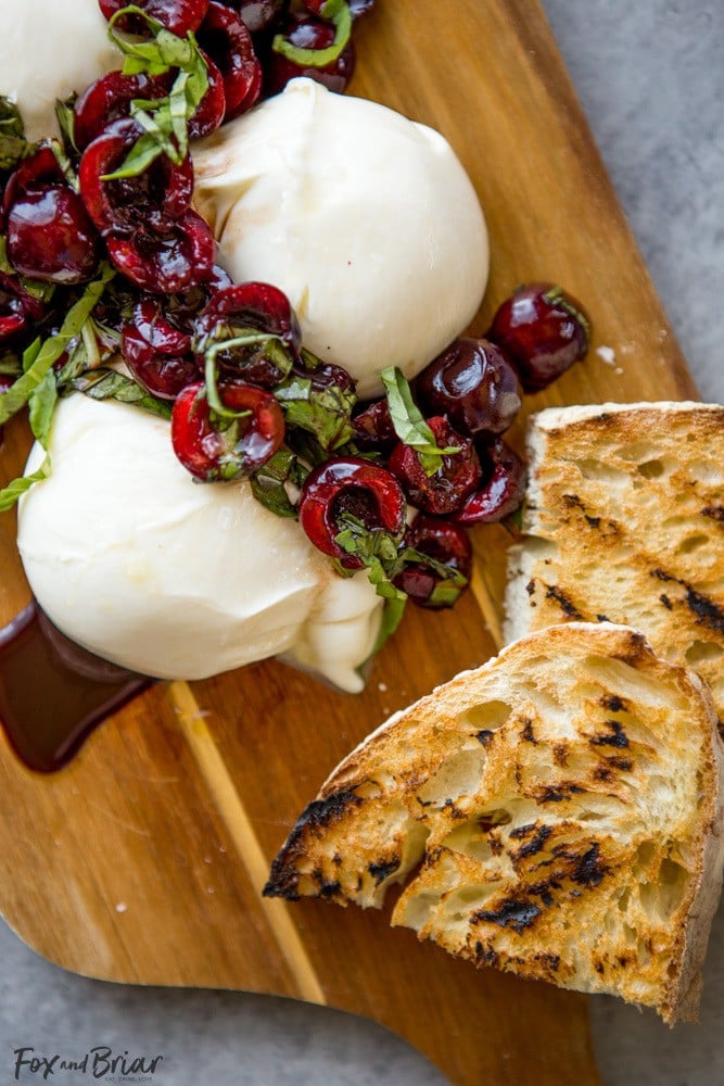 This Burrata with Balsamic Cherries and Basil the ultimate summer appetizer! Creamy, fresh burrata paired with juicy cherries and fragrant basil uses summer produce at its best, and no cooking required! Summer appetizers | Cherry Recipes | basil Recipes | burrata Recipes | party appetizers