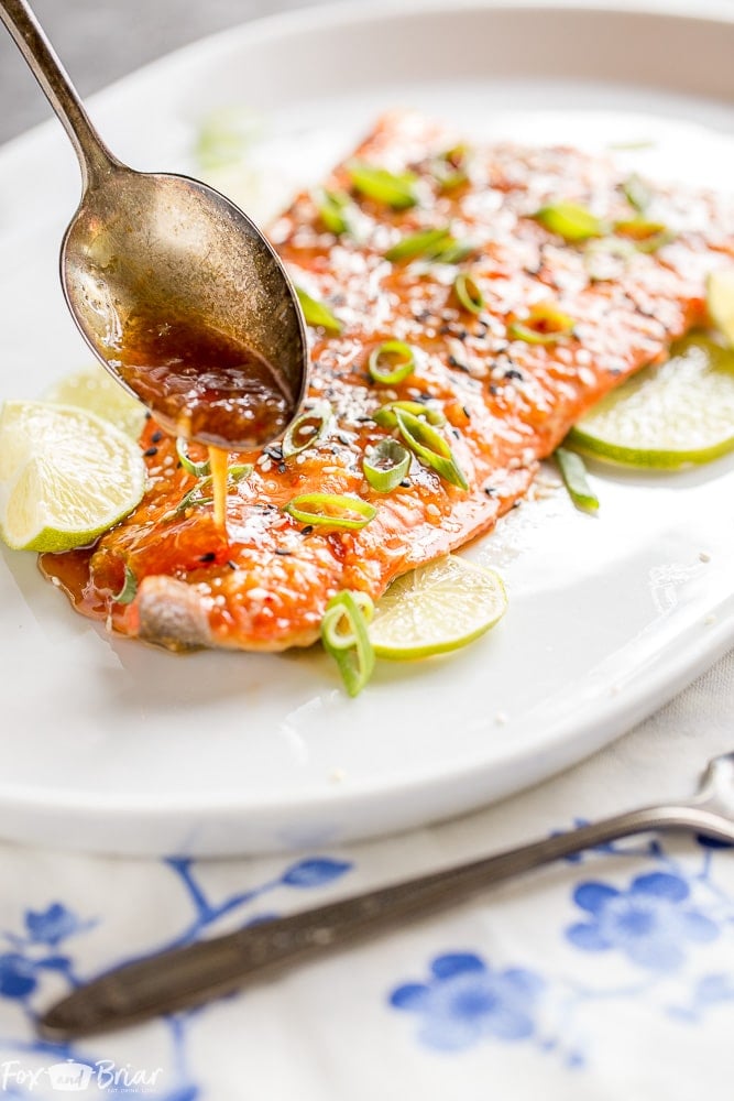 This Baked Sweet Chili Garlic Salmon will be your favorite way to eat salmon! This quick and easy salmon recipe only takes 20 minutes and is packed with sweet, tangy and spicy Asian flavors that will become a family dinner favorite. |Easy dinner recipe | 20 minute dinner | Quick Dinner Recipe | Salmon Recipe | Fish Recipe | Asian Salmon 