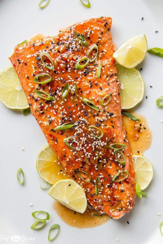 This Baked Sweet Chili Garlic Salmon will be your favorite way to eat salmon! This quick and easy salmon recipe only takes 20 minutes and is packed with sweet, tangy and spicy Asian flavors that will become a family dinner favorite. |Easy dinner recipe | 20 minute dinner | Quick Dinner Recipe | Salmon Recipe | Fish Recipe | Asian Salmon 