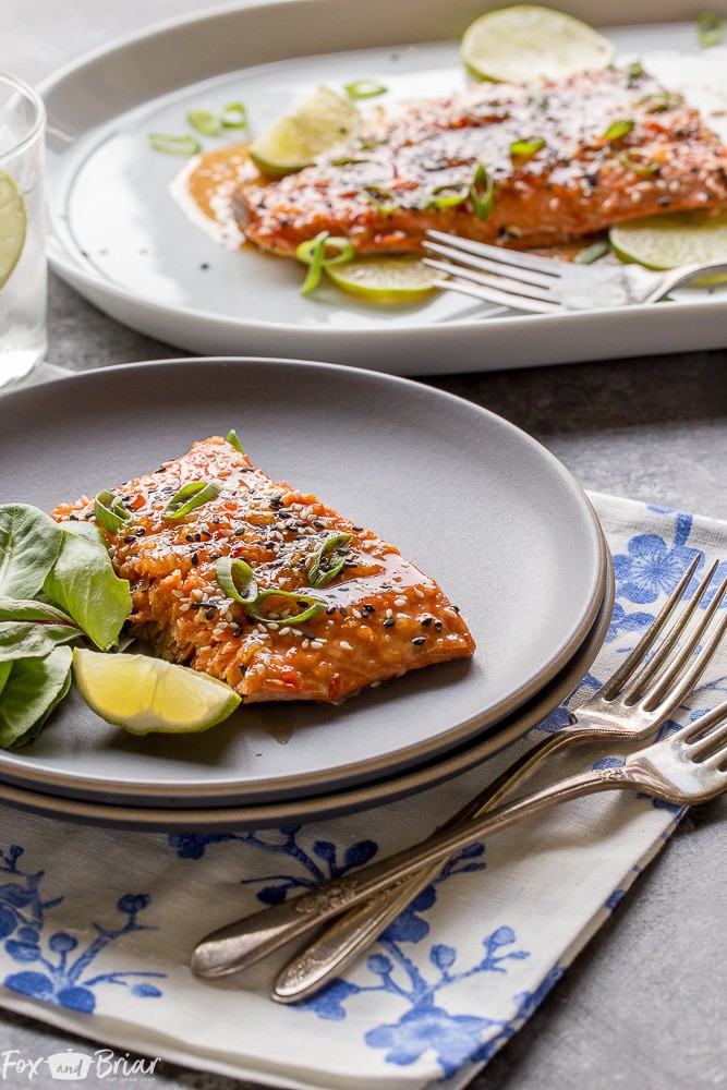 This Baked Sweet Chili Garlic Salmon will be your favorite way to eat salmon! This quick and easy salmon recipe only takes 20 minutes and is packed with sweet, tangy and spicy Asian flavors that will become a family dinner favorite. |Easy dinner recipe | 20 minute dinner | Quick Dinner Recipe | Salmon Recipe | Fish Recipe | Asian Salmon 