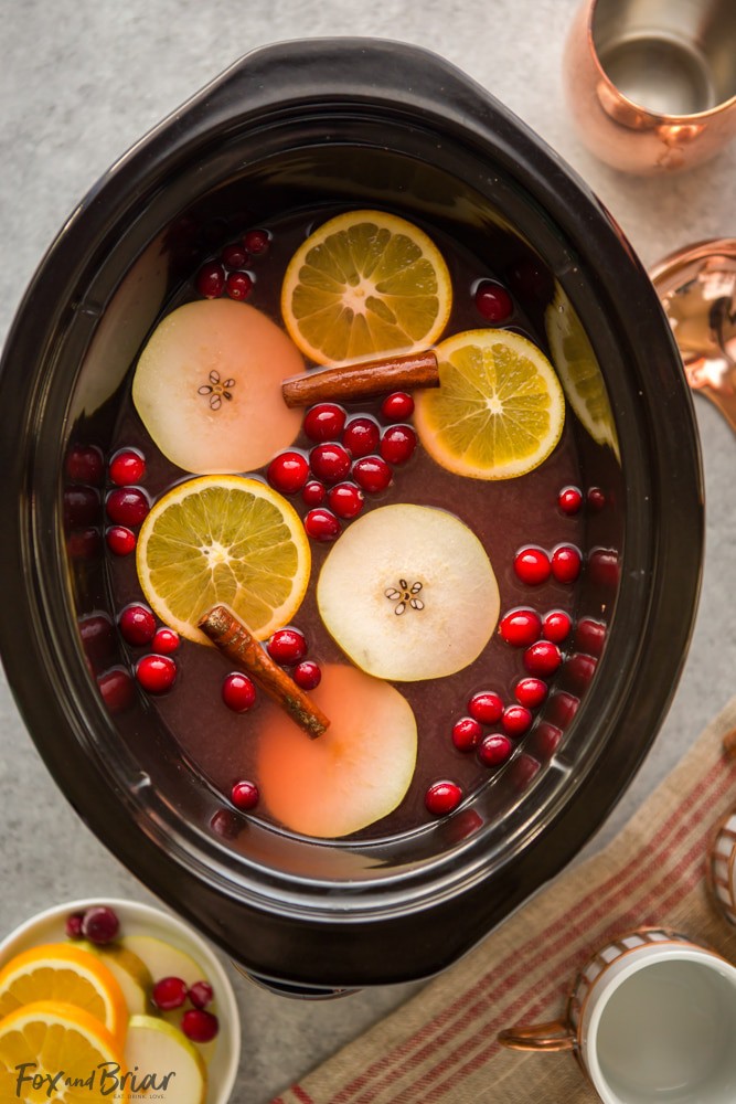 This Crock Pot Cranberry Pear Cider is made from scratch in your slow cooker! A festive, warm fall and winter beverage, perfect for Thanksgiving or Christmas! |crock pot recipe | Slow Cooker Recipe | Cider in the crockpot | slow cooker cider recipe | fall drink | warm drinks | non-alcoholic drink for christmas | thanksgiving drink