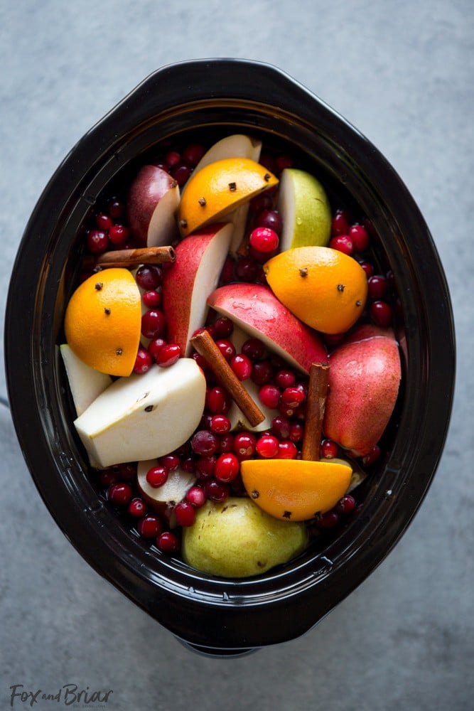 This Crock Pot Cranberry Pear Cider is made from scratch in your slow cooker! A festive, warm fall and winter beverage, perfect for Thanksgiving or Christmas! |crock pot recipe | Slow Cooker Recipe | Cider in the crockpot | slow cooker cider recipe | fall drink | warm drinks | non-alcoholic drink for christmas | thanksgiving drink