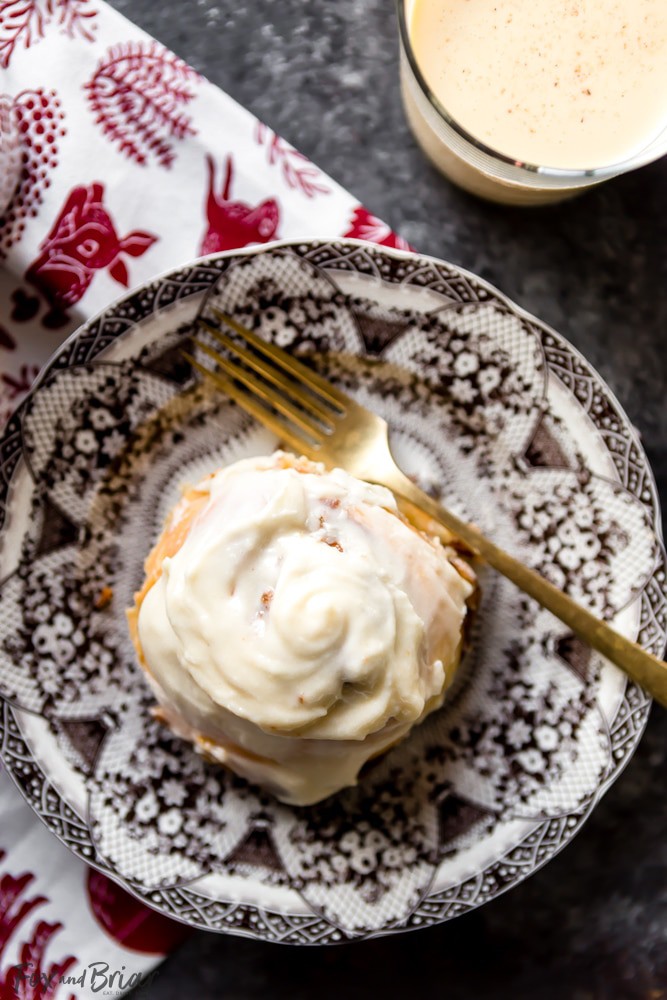 These giant, soft, Eggnog Cinnamon Rolls are the perfect Christmas morning breakfast! Gooey, pillowy and full of cinnamon spice with an extra holiday pop of eggnog flavor in the creamy icing. | Christmas Morning Breakfast Recipe | Eggnog Recipes | Holiday Recipe | Christmas Brunch Recipe | Holiday Brunch | Holiday baking | Christmas Baking