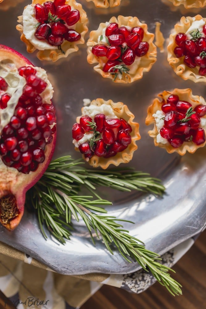 These Pomegranate Goat Cheese Bites with Honey and Thyme are an easy party appetizer that is sure to impress your guests! | easy party appetizer | phyllo bite recipe | Phyllo dough recipe | mini phyllo shells appetizers | phyllo dough hors d'oeuvres recipes | finger foods | holiday appetizer recipe | elegant party appetizer | girls night | apps | new years eve party recipe | thanksgiving appetizer