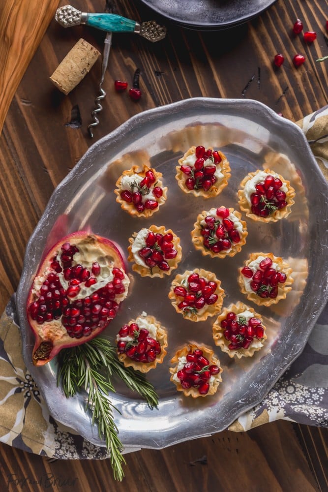 These Pomegranate Goat Cheese Bites with Honey and Thyme are an easy party appetizer that is sure to impress your guests! | easy party appetizer | phyllo bite recipe | Phyllo dough recipe | mini phyllo shells appetizers | phyllo dough hors d'oeuvres recipes | finger foods | holiday appetizer recipe | elegant party appetizer | girls night | apps | new years eve party recipe | thanksgiving appetizer | 