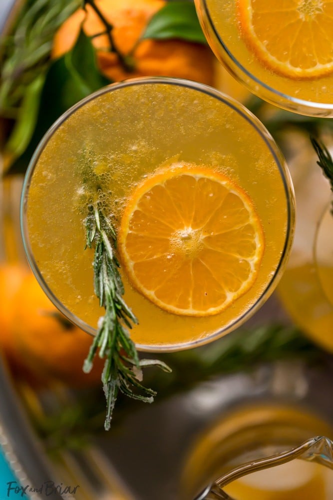 This non-alcoholic Rosemary Clementine Sparkler is a sophisticated mocktail perfect for the holidays. Non-Alcoholic Recipes | Pregnancy drinks | Drinks for teens | Baby Shower drinks | Dry January | Winter Mocktail | Non-alcoholic party drink | Sparkling mocktail | New Years Mocktail 