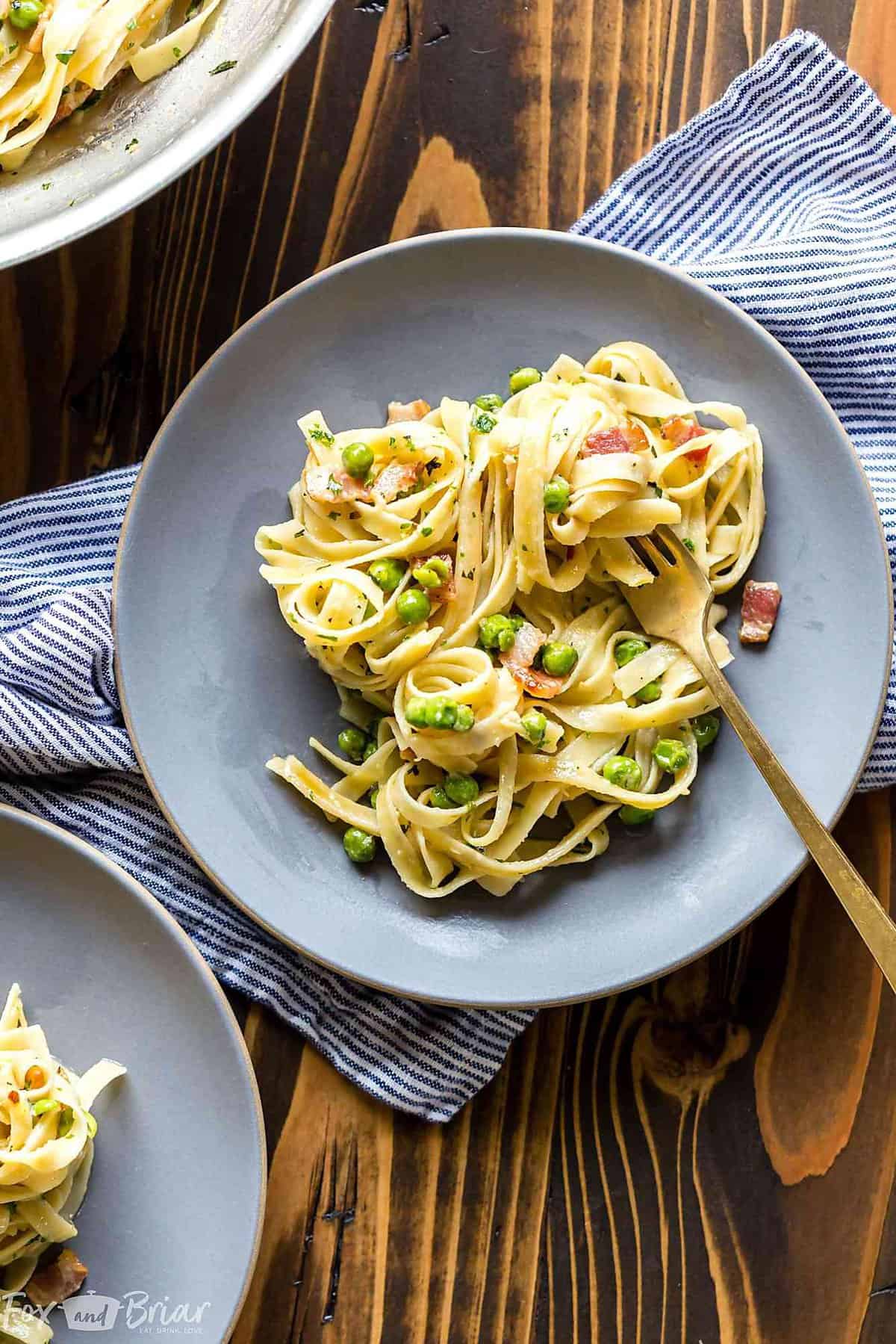This quick Creamy Pasta with Pancetta and Peas only takes 15 minutes and is an easy and elegant dinner for any night of the week! @QFCgrocery #QFCdelivery #sponsored Pasta with peas and bacon | Pasta with peas and pancetta recipe | noodles with peas and bacon | cramy pasta recipe | Easy pasta recipe | easy dinner recipe | 15 minute dinner | quick pasta recipe | date night recipe | peas and bacon cream sauce