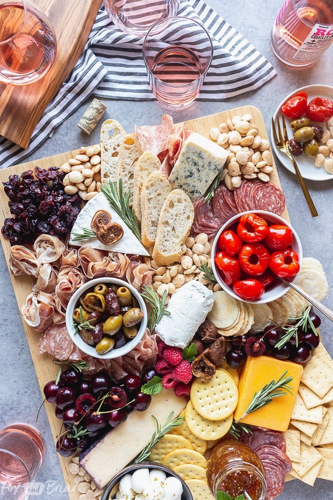 No party is complete without an epic charcuterie board.  Follow these step by step photos to learn how to make a charcuterie board. | how to make a cheese board | party appetizer | holiday appetizer | cheese and wine | Charcuterie ideas | Cheeseboard ideas | cheese board for holidays | summer cheese board | Fall Cheeseboard | Party platter #ad @qfc