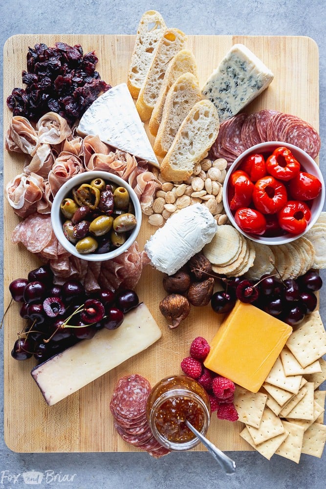 No party is complete without an epic charcuterie board.  Follow these step by step photos to learn how to make a charcuterie board. | how to make a cheese board | party appetizer | holiday appetizer | cheese and wine | Charcuterie ideas | Cheeseboard ideas | cheese board for holidays | summer cheese board | Fall Cheeseboard | Party platter #ad @qfc