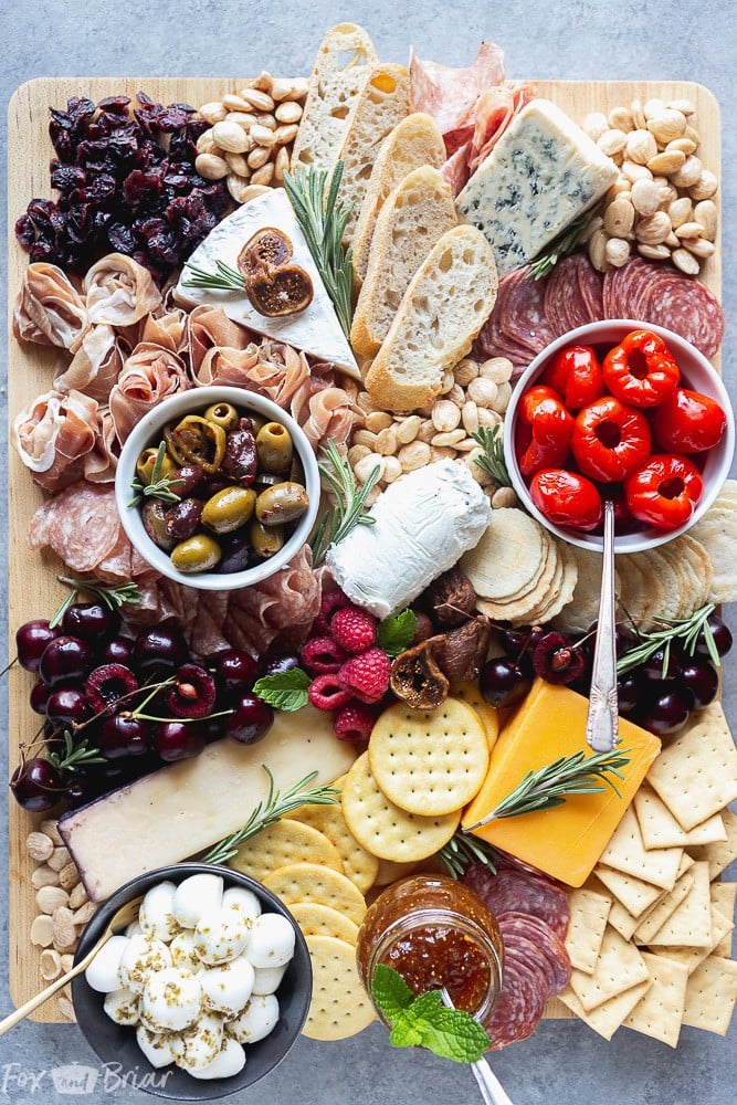 No party is complete without an epic charcuterie board.  Follow these step by step photos to learn how to make a charcuterie board. | how to make a cheese board | party appetizer | holiday appetizer | cheese and wine | Charcuterie ideas | Cheeseboard ideas | cheese board for holidays | summer cheese board | Fall Cheeseboard | Party platter #ad @qfc